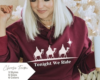 May include: Burgundy hooded sweatshirt with a white graphic of three wise men riding camels with a star above them. The text "Tonight We Ride" is below the graphic.
