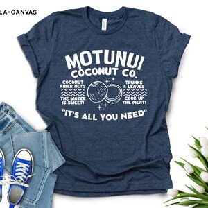 May include: A navy blue t-shirt with white text that reads "Motunui Coconut Co." and "It's all you need." The text is surrounded by a graphic of two coconuts and the words "Coconut fiber nets, the water is sweet! Trunks & leaves, cook up the meat!"
