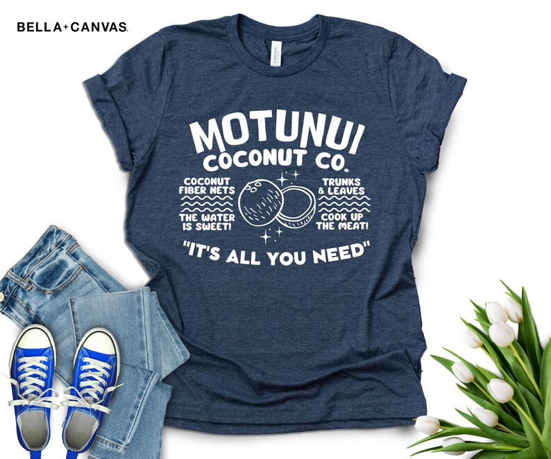 May include: A navy blue t-shirt with white text that reads "Motunui Coconut Co." and "It's all you need." The text is surrounded by a graphic of two coconuts and the words "Coconut fiber nets, the water is sweet! Trunks & leaves, cook up the meat!"