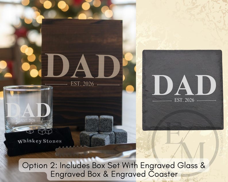 a set of items, including a wooden box with the word "DAD" engraved on it, a glass, and a set of gray stones. The items are arranged on a table, with a blurred background that includes a Christmas tree.