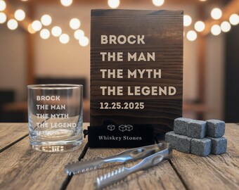 May include: A whiskey gift set with a clear glass, a wooden sign, whiskey stones, tongs, and a black velvet bag. The glass and sign read "BROCK THE MAN THE MYTH THE LEGEND 12.25.2025". The bag says "Whiskey Stones".