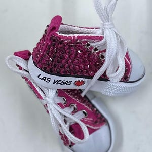 Pink Doll Shoes with Rhinestones. 3 inches with the words, “Las Vegas”.