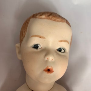 Gebruder Huebach Whistling Jim full porcelain body boy doll 13 inches reproduction.