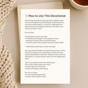 May include: A devotional book titled "How to Use This Devotional" with text on a white background. The book is open, and a cup of tea sits in the upper right corner. The text describes the devotional's purpose and content.