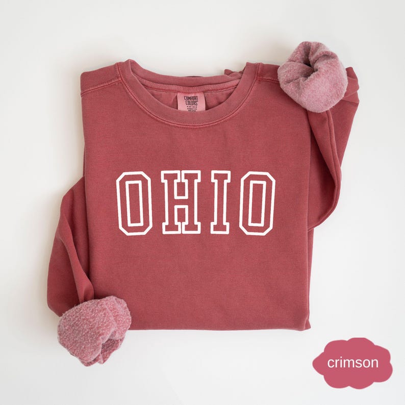 May include: Crimson red sweatshirt with the word "OHIO" in white block letters.