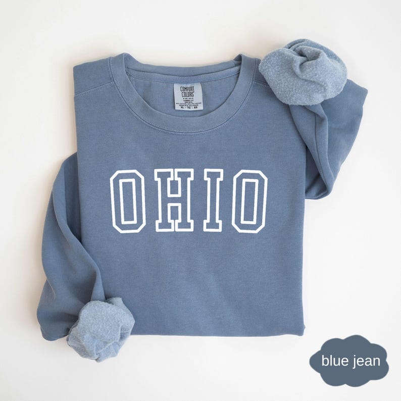 May include: A blue jean sweatshirt with white lettering that says "OHIO".