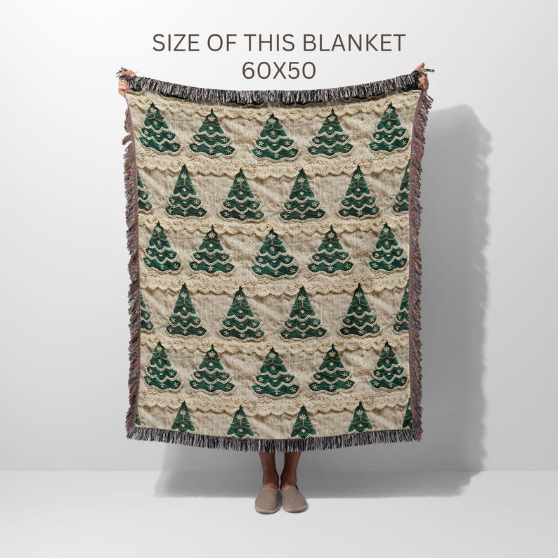 May include: A cream-colored throw blanket with a green Christmas tree pattern. The blanket is 60 inches by 50 inches.