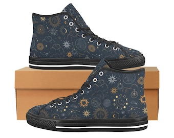 May include: High-top canvas sneakers with a celestial design. The navy blue shoes feature a pattern of suns, moons, stars, and constellations in gold and white. The sneakers have black soles and laces, and are displayed on a brown box.