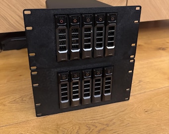 May include: A black server rack with multiple hard drives installed. The rack is made of metal and has a sleek, modern design.