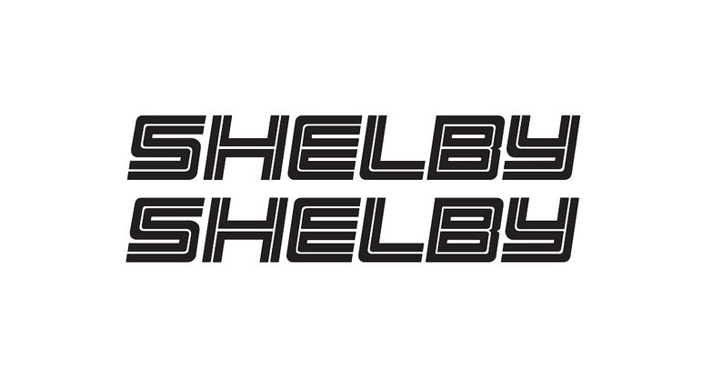 May include: Two black and white "Shelby" logos stacked on top of each other. The logos are in a retro, stylized font.
