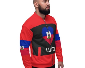 May include: Red zip-up jacket with black and blue accents. The jacket features a heart-shaped design with the Haitian flag and the word "HATI" in white. The sleeves have blue and red stripes with the Haitian flag.