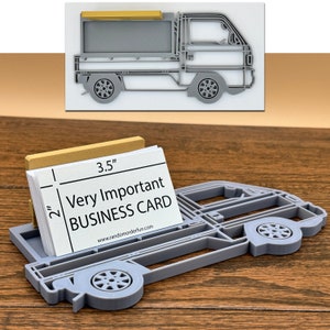 May include: Gray 3D printed pickup truck business card holder. The holder is 3.5 inches wide and 2 inches tall. The business card reads "Very Important Business Card" and includes a website address.