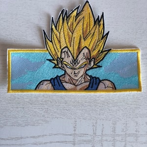 May include: An embroidered patch featuring a yellow-haired anime character with a blue and yellow background. The character has a serious expression and is wearing a blue and black outfit.