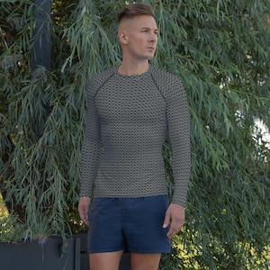 May include: A long-sleeved shirt with a chainmail pattern in black and white. The shirt has a crew neck and a fitted silhouette.