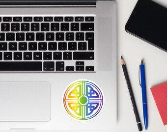 May include: A round sticker with a rainbow Celtic knot design. The sticker features a white background and a colorful geometric pattern in shades of red, orange, yellow, green, blue, and purple. The sticker is on a laptop.