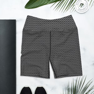 May include: Black athletic shorts with a white geometric pattern. The shorts have a high waist and a fitted silhouette.
