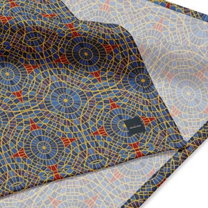May include: A blue and gold fabric with a repeating pattern of red stars and concentric circles. The fabric has a subtle texture and a slightly faded look.