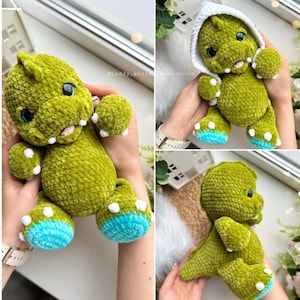 May include: A green crocheted dinosaur toy with white and blue accents. The dinosaur is sitting in a person's hands.