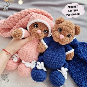 May include: Two crocheted teddy bears wearing pajamas. The pink bear has a white crocheted hat. The blue bear has a blue crocheted hat. The bears are holding hands. The image includes the text "CROCHET PATTERN PDF ENGLISH".
