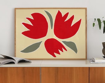 May include: A framed art print featuring a bold floral design in red and gray on a cream background. The artwork is displayed above a wooden cabinet, with a mid-century modern chair in the foreground. A small potted plant and books are also visible.