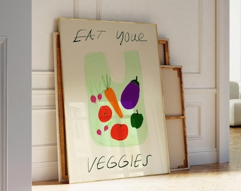 May include: A framed print with a green plastic bag filled with vegetables. The text "EAT your VEGGIES" is written in black marker on the print.