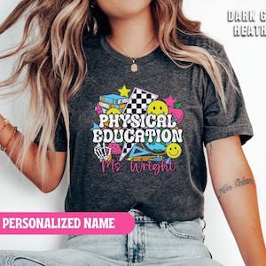 May include: Dark grey heather t-shirt with a colorful graphic design that says "Physical Education Ms. Wright".