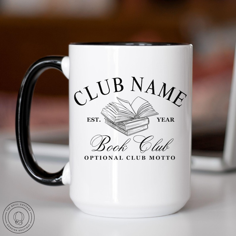May include: White ceramic mug with a black handle and rim. The mug features the text "CLUB NAME" above an illustration of books, with "Book Club" and "OPTIONAL CLUB MOTTO" below. The mug is designed for book clubs.