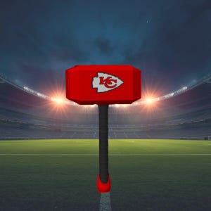 May include: A red hammer featuring the Kansas City Chiefs logo on its head. The hammer has a black handle with a red base. The background shows a football stadium at night.