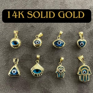 May include: Eight 14K solid gold pendants featuring blue and black evil eye motifs in various shapes including circles, hearts, triangles, shells, and hamsa hands. Each pendant has a gold bail at the top for attachment to a necklace chain.
