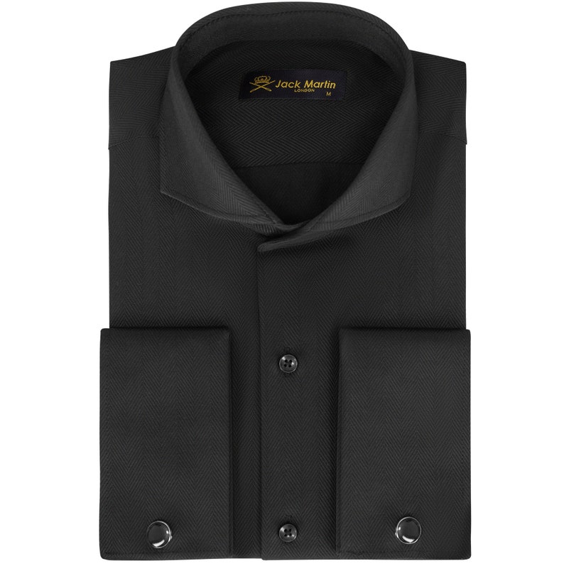 May include: Black dress shirt with a pointed collar and French cuffs. The shirt has a herringbone pattern and a gold label with the text "Jack Martin London M".