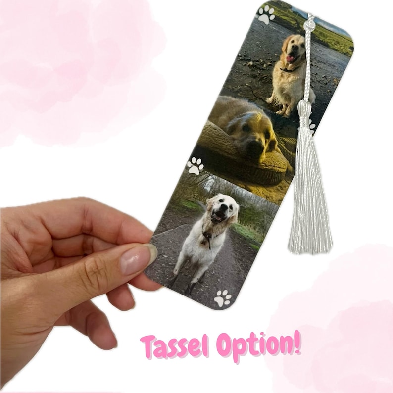 May include: A white bookmark with three photos of a golden retriever dog. The bookmark has a white tassel and paw prints on the bottom.