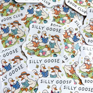 May include: A collection of stickers featuring cartoon geese reading books. Some stickers say "Book Club" and others say "Silly Goose". The geese are wearing hats and glasses, and are surrounded by flowers and coffee cups.