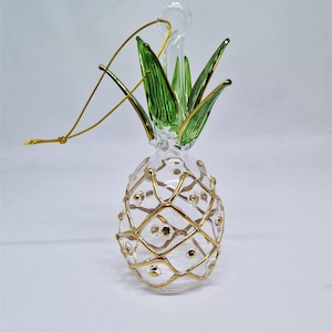 Clear Pineapple with gold design- Christmas ornaments, aromas and various shapes of glass have been formed and colored in the ancient Egypt.