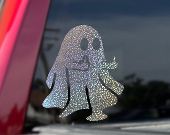 May include: A silver glitter ghost sticker on a red truck tailgate.