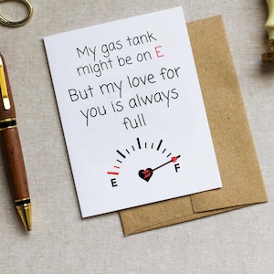 May include: A white card with a black and red gas gauge graphic and the text "My gas tank might be on E But my love for you is always full".