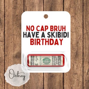May include: White card with red text that says "No Cap Bruh Have A Skibidi Birthday". A rolled up dollar bill is visible in a clear plastic pocket on the card.