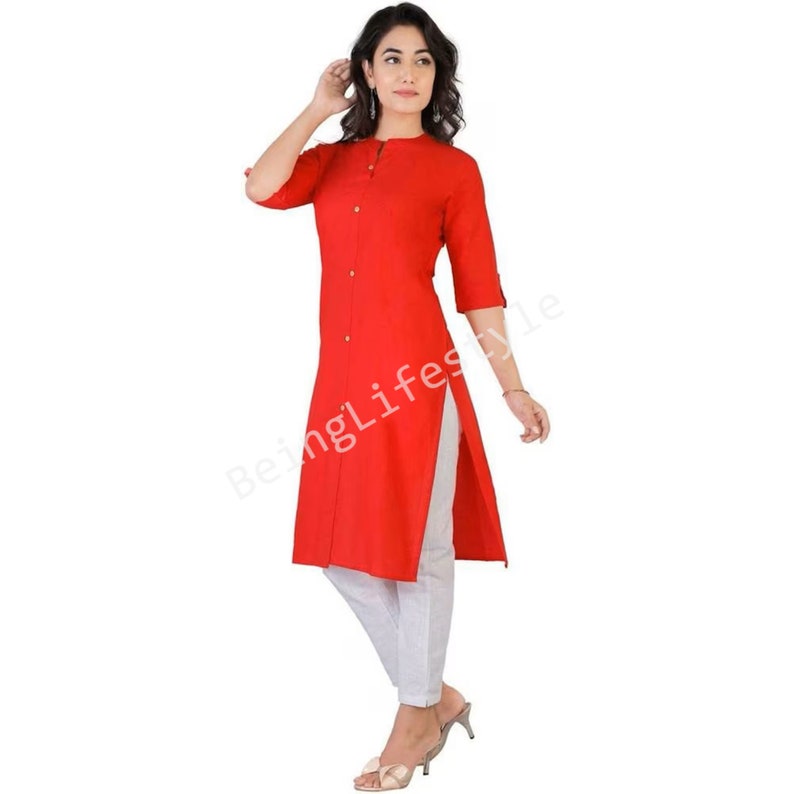 May include: A red long-sleeved kurta with a button-up front and a side slit. The kurta is worn with white pants.