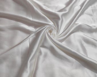 May include: White satin fabric with smooth, flowing folds and a soft, luxurious texture.