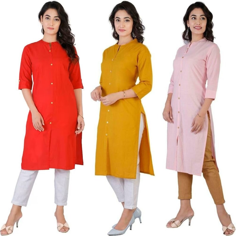 May include: Three long-sleeved button-down shirts in red, yellow, and pink. Each shirt has a side slit and a mandarin collar.