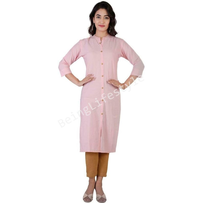 May include: A pink long-sleeved button-down shirt with a mandarin collar. The shirt is made of a lightweight fabric and has a relaxed fit.