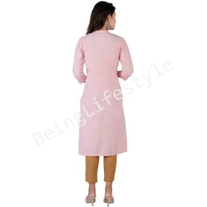 May include: A pink long-sleeved kurta with a button-up front and a slightly flared hem. The kurta is made of a soft, lightweight fabric and is perfect for warm weather.