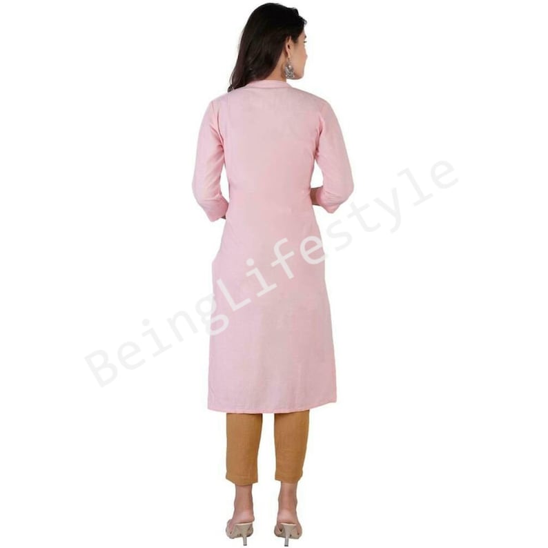May include: A pink long-sleeved kurta with a button-up front and a slightly flared hem. The kurta is made of a soft, lightweight fabric and is perfect for warm weather.
