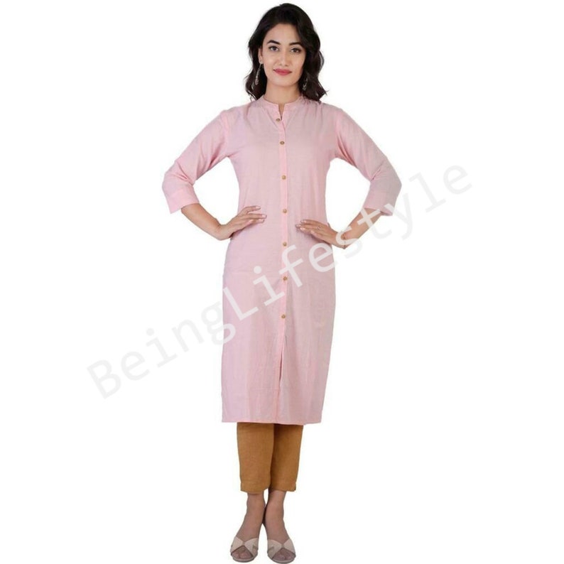 May include: A pink long-sleeved button-down shirt with a mandarin collar. The shirt has a single pocket on the left side and is made of a lightweight fabric.