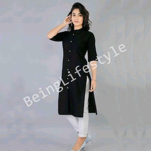May include: A black long-sleeved kurta with a button-up front and a side slit. The kurta is worn with white trousers and black heels.