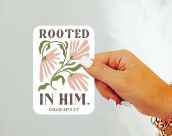 May include: A white sticker with a floral design and the text "Rooted in Him. Colossians 2:7".