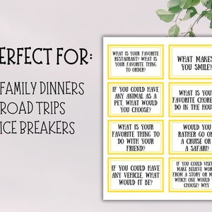 May include: A white card with yellow-bordered question prompts for family dinners, road trips, and ice breakers. Questions include favorite restaurant, pet choice, and what makes you smile.
