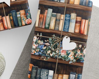 May include: Gift wrap featuring a watercolor illustration of a bookshelf filled with books. The wrapping paper is tied with twine and a heart-shaped tag. Floral accents of pink, blue, and white flowers are also present.
