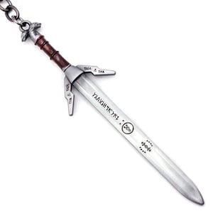 May include: A silver-toned metal sword keychain featuring a brown handle, a crossguard with engraved symbols, and a blade inscribed with runic characters. The pommel is shaped like a wolf head, and a metal chain is attached to the top of the hilt.