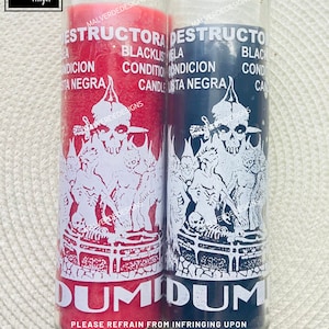 May include: Two glass candle jars with red and black wax. The jars have white labels with the text "DESTRUCTORA" and "DESTRUCTO" in Spanish. The labels also include the text "BLACKLIST CONDITION CANDLE" and "DUMIDUM". The text "PLEASE REFRAIN FROM INFRINGING UPON THE COPYRIGHT OF MALVERDEDESIGNS." is printed below the candles.