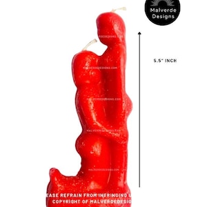 May include: A red candle shaped like a human figure, approximately 14 cm tall. The candle has a textured surface and a wick. The text "Malverde Designs" and a website address are visible. The base of the candle has text that reads "EASE REFRAIN FROM INERINGING U COPYRIGHT OF MALVERDEDESIG".